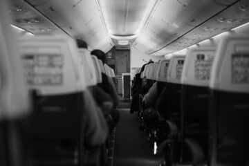Inside the passenger plane inside the cabin in black and white