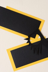 black and yellow paper rectangles with jagged abstract shape on ivory