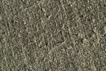 dark creative background: reverse side of black-primed linen canvas, uneven lighting, color toning