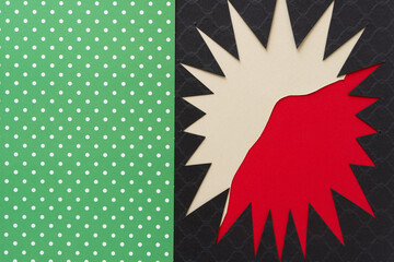 irregular abstract shape (starburst, sun) - black on red and beige with green/white dots