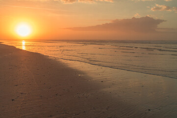Fototapeta na wymiar Sun Rising over Beach