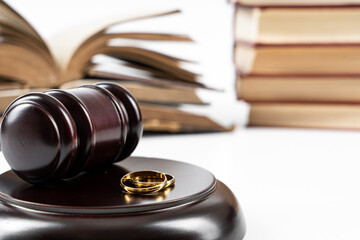 Law and Justice concept. Judge gavel on white background with two golden wedding rings