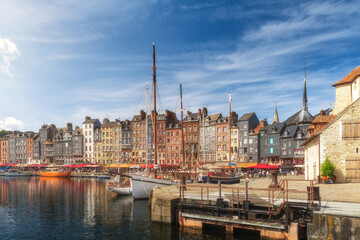The harbour of Honfleur port, Normandy, France with colorful buildings, boats and yachts