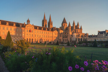 Caen, Normandy, France. Beautiful Abbey of Saint-Etienne or Abbaye aux Hommes and city hall at sunrise - obrazy, fototapety, plakaty