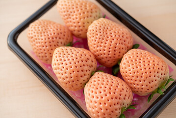 パック入りの6個の白いちご
