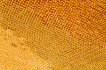 reflection of golden tiled wall of thai temple, abstract background