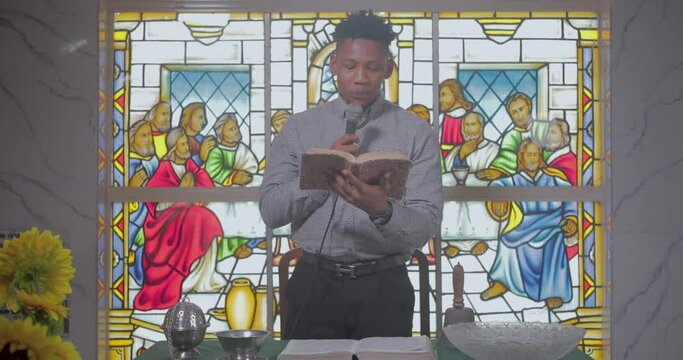 Young pastor reading from a bible