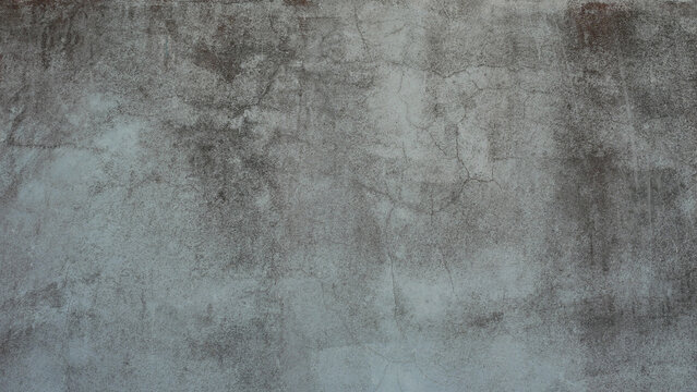 The old cement wall was weathered, the surface was scratched, the surface was scratched and damaged. For a mysterious retro-conservative background.