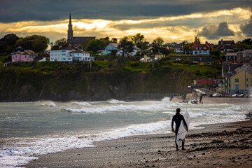 surfers at the beach during a sunset 