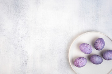 Coloring Easter eggs with natural dye carcade tea from hibiscus flowers. Trendy very peri colour with marble effect.