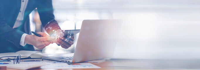 A Businessman working on tablet computer analysis economy finance and sale data growth on interface icons, Banking, Finance, Business Strategy on global business Digital network connection technology.