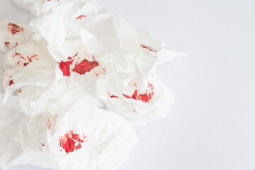 red blood stains on white tissue against white background.