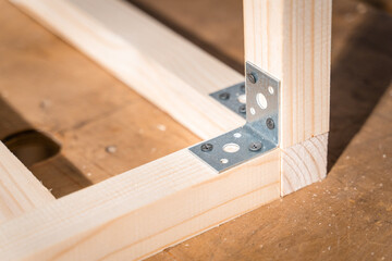 Corner connection of wooden bars with iron corners and black self-tapping screws