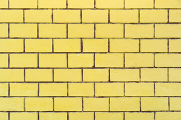 empty yellow color paint brick wall or floor with top view table loft and retro on golden brickwork frame for texture background and vintage wallpaper or interior brickwall and exterior construction