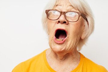 Portrait of an old friendly woman vision problems with glasses light background