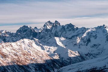 Fototapeta premium Snowy mount Ushba. Greater Caucasus ridge. Sunny day. Before suset. View from russian side