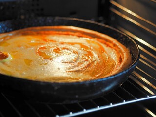 This autumn round homemade pumpkin pie is baked in an even pan in the home oven. Healthy homemade food.