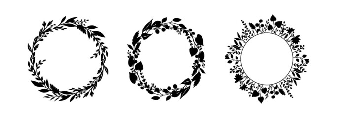 Set of silhouettes of wreaths of field herbs and plants. Black vector round frames isolated on white background. Medicinal flowers, twigs, leaves. The plant elements are hand drawn in ink. 