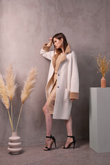 Fashion woman in trendy faux fur coat.