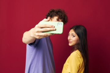 Fototapeta premium nice guy and girl take a selfie posing hug isolated background