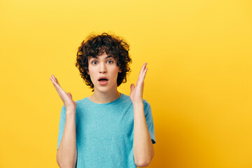 shocked guy in blue t-shirt gesturing with his hands - obrazy, fototapety, plakaty