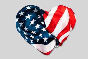 A heart made of an American flag, isolated on a gray background. The concept of patriotism and national holidays of the USA