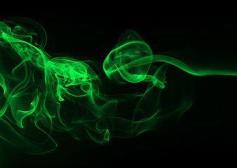 Green smoke abstract on black background for design. darkness concept