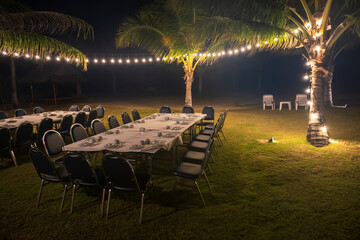 group dinner by beach with light decoration