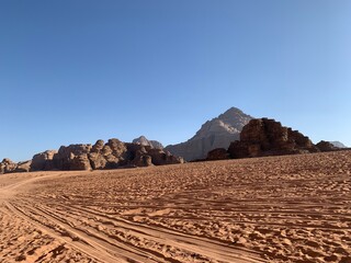 car, truck, cabriolet with tourists rides through the desert through the rocks