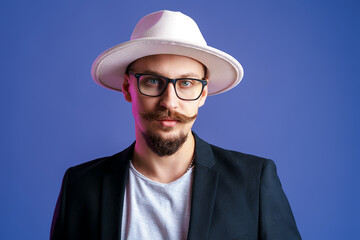 Portrait of Handsome bearded man in white wide-brimmed hat and blazer who looking at camera 