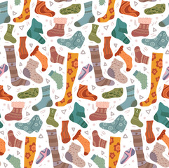 Vector seamless pattern with various cozy knitted socks and stockings on white background. Texture with hand drawn cartoon clothes and doodle decorations in warm colors with ornaments