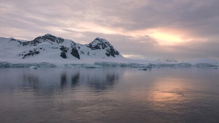 Icebergs and glaciers in Antarctica. Beautiful blue iceberg with mirror reflection floats in open ocean. Global Climate changes video - the glaciers are warming and melting faster.