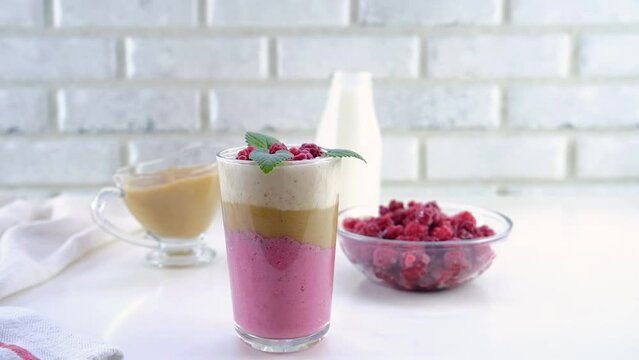 Delicious layered yogurt dessert with applesauce, raspberries and banana. The dessert is decorated with raspberries and mint and served in a glass. Step-by-step instruction. Step 0.