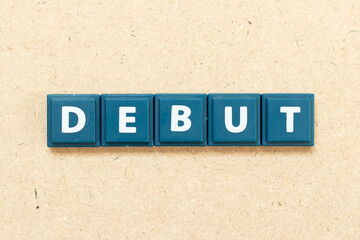 Tile alphabet letter in word debut on wood background
