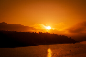 Beautiful sunrise over the lake with warm skies and sparkling reflections on the water surface.