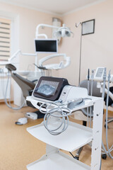Modern dental clinic, dental chair and other accessories used by dentists in medical light.