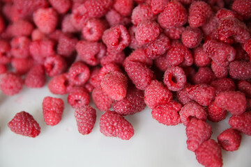  lots of ripe raspberries on a white background, top view