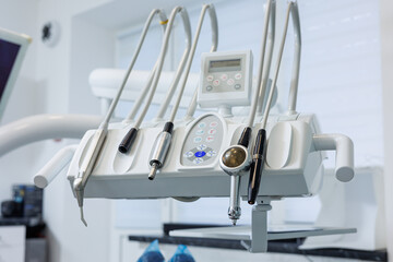 Modern dental clinic, dental chair and other accessories used by dentists in medical light.