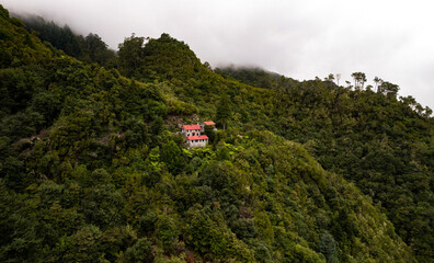 Lonely house on hill in mountains