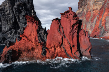 Red rocky formation in sea