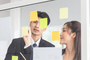 Young business people meeting at office and use post it notes to share idea. Office worker discussing together in conference room during meeting at office, Brainstorming concepts. 