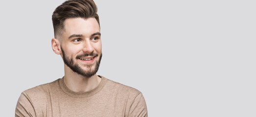 Portrait of handsome smiling young man, Smiling joyful cheerful men closeup isolated studio shot, Panoramic banneк.