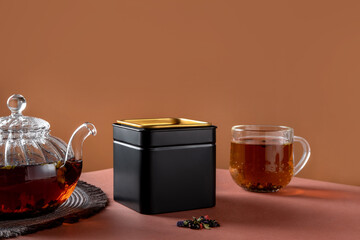 Black metal packaging for tea. Tea branding and packaging mockup. Blank tea packaging mockup with...