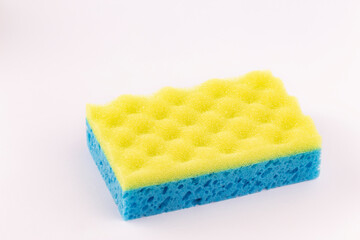 Yellow- blue sponge for washing dishes close-up