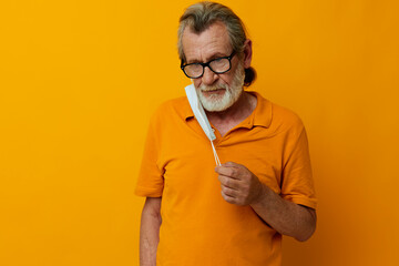 Senior grey-haired man with glasses face shield safety cropped view