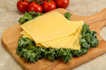 Sliced Gauda cheese over board