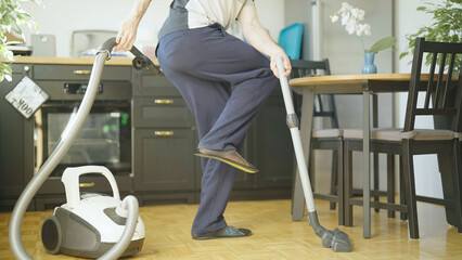 Person doing housework with vacuum cleaner and vacuuming own fart - obrazy, fototapety, plakaty