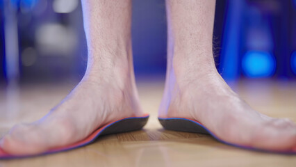 Person feet testing the arch support insole flexibility
