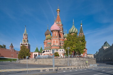 The Cathedral of the Intercession of the Most Holy Theotokos, on the Moat (St. Basil's Cathedral) and the Spasskaya Tower of the Moscow Kremlin, Russia