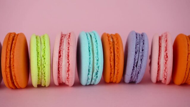 Delicious colorful french macaroons cookies. Horizontal camera movement.